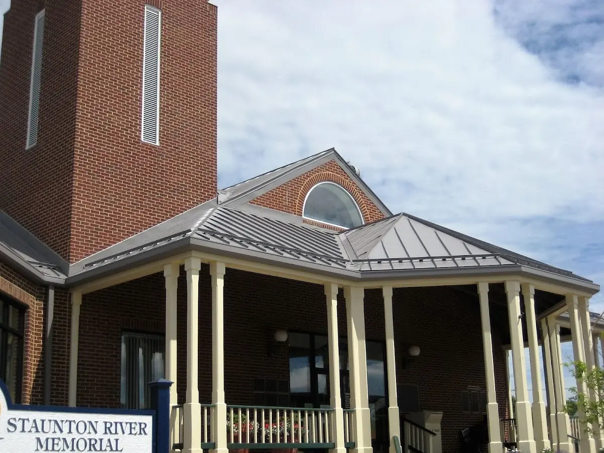 Skilled roofing craftsmen working on a residential roof in Neosho
